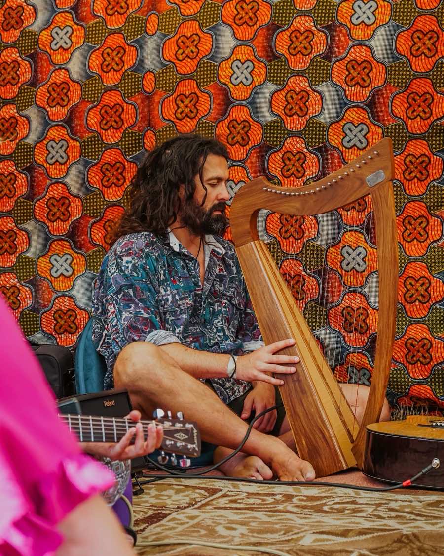 Ian Jamieson playing harp at a song circle
